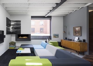 The open living space showcases the bright, streamlined furniture pieces of Chabauty's own creation (apart from a few vintage pieces, the bulk of the furniture in the home is custom-made).