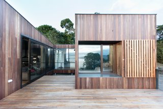 Operable timber shutters and screens offer protection from extreme weather. Zoning the house into three distinct masses creates a partly sheltered courtyard to make this year-round blending of the indoors and outdoors possible.