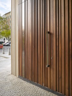 The Museum for Architectural Drawing in Berlin, designed by Russian firm SPEECH Tchoban & Kuznetsov, has a wooden door that mimics the structure's textured concrete exterior.