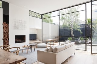 50 Modern Homes With Floor-to-Ceiling Windows - Photo 41 of 50 - For Kathryn Robson and Susie Cohen—the Melbourne-based designer duo behind this Victorian remodel—elegance lies in well-executed handcrafted details. With this bespoke design philosophy, the two set out to transform their clients’ dark single fronted Victorian home into a light, open space comfortable year-round for the couple and their two small children. The designers explain, "These steel windows played an integral part in making the interior feel larger and more open by blurring the boundaries between the interior and exterior." 