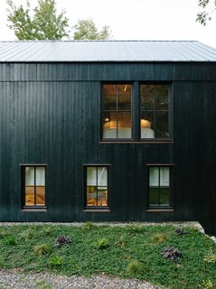 A Passive House and "Sauna Tower" Join a 19th-Century Barn in the Hudson Valley - Photo 3 of 13 - The main house is constructed from structural insulated panels from Vermont Timber Frames and clad in charred cedar. The roof panels are by Agway Metals.