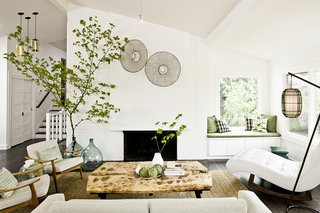 Jessica Helgerson Interior Design updated a split-level ranch house in Portland by introducing a clean white palette and vintage furnishings.