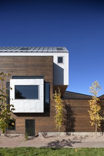 Mitchell says that the red cedar "provided a nice level of contrast from the white siding on top and helps to establish those two spaces as distinctly separate." The siding is from James Hardie.