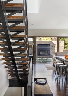 Mitchell wanted to detail the solid oak staircase with that same sense of openness, even though its materials are heavy. "We used a lot of raw steel and wood on the interior of the home," Mitchell said. "This carries the authenticity of real materials from the building exterior to the building interior." A custom fireplace sits on the patio.