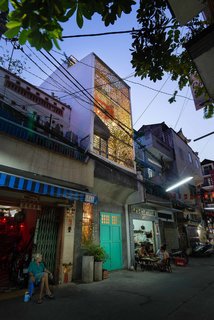 A Narrow Courtyard Joins a Unique Two-Family Home in Saigon - Photo 1 of 10 -