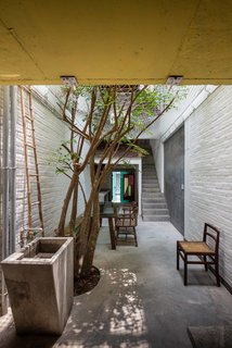 A Narrow Courtyard Joins a Unique Two-Family Home in Saigon - Photo 4 of 10 -