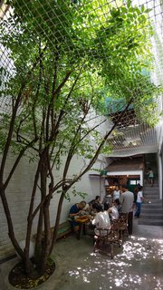 A Narrow Courtyard Joins a Unique Two-Family Home in Saigon - Photo 5 of 10 -