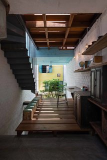 A Narrow Courtyard Joins a Unique Two-Family Home in Saigon - Photo 7 of 10 -
