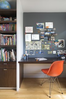 10 Essential Tips For Creating a Hardworking Home Office - Photo 5 of 10 - Upstairs, their son’s bedroom features a built-in walnut bookshelf and desk. Smart details—like the magnetic paint in lieu of a bulletin board—help keep the space tidy. The chair is an Eames Molded Fiberglass Side Chair.