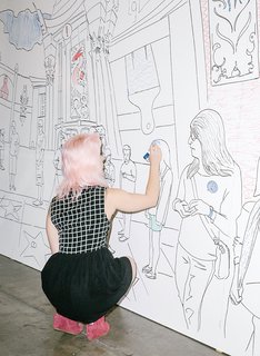 A visitor works on IdeaPaint’s dry-erase coloring wall.