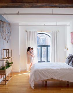 Aurora Ray, a color-gradient wallpaper inspired by the sunset as seen from Red Hook, accents the master bedroom, furnished with a custom bed frame by VIDIVIXI. The couple also designed a collection named after their daughter, Willow, exploring the movement of water and trees.