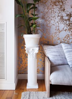 Naturally, the Copes are hands-on with all of the interior touches throughout their home (at one point, they even had a bed frame fashioned from shipping pallets). In the living room, they’ve styled an architectural fragment, sourced from local salvage yard Big Reuse (formerly Build It Green), and re-painted it white to create a striking plant display.