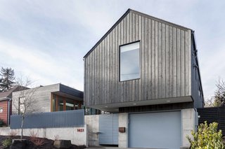 In Seattle’s Capitol Hill neighborhood, Heliotrope Architects and Dovetail General Contractors teamed up to create a spacious 3,953-square-foot residence with simple forms and defined functions. A cedar-clad front facade features one of the home’s defining design elements: a cantilevered gable that appears to float over the garage. The project is composed of two unique forms, divergent in convention but complementary in execution. 