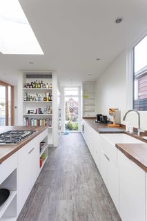 12 Striking Examples of Clerestory Windows in Modern Homes - Photo 3 of 12 - The kitchen, framed by Loewen windows, features walnut butcher block countertops, custom made by Dovetail, a Hansgrohe faucet, Franke apron sink, Miele refrigerator and oven, and Thermador cooktop.