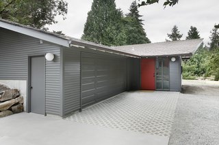 "The stable/garage was built with two intersecting gable roof forms," Schaer says, which didn't match up with the inteiror spaces within. "In order to provide a unified, singular main space, we dropped a flat ceiling at the entrance and linked it up with the main gable visible from the street."