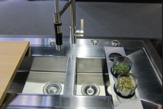 To get rid of gunk in your kitchen or bathroom drains, boil two cups of water. Pour half a cup of baking soda, then half a cup of vinegar, into the drains. Immediately after, pour the boiled water down the drain, and cover the opening with a pot or small saucepan to let the heat, baking power, and soda work to release the grime. Repeat as needed. 