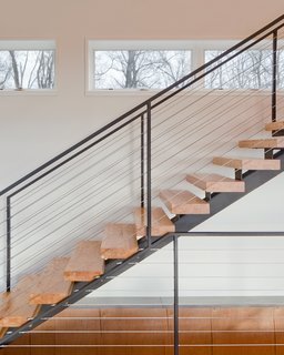 "The clients desired a maintenance-free, year-round home using the ultimate in ‘green’ building methodologies," Mulvena says. The staircase is an example of the construction’s mindset: it is made from the leftover laminated veneer lumber used on the roof.