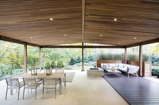 How to Refresh a Midcentury Gem in Quebec? Winter-White Everything - Photo 5 of 12 - On the other end of the property, a terrace faces northeast, overlooking a small stream flowing into the Riviére des Prairies.