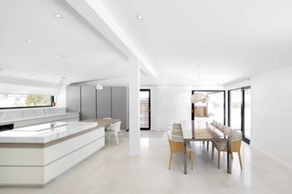 How to Refresh a Midcentury Gem in Quebec? Winter-White Everything - Photo 9 of 12 - Painted beams serve to separate interior spaces.