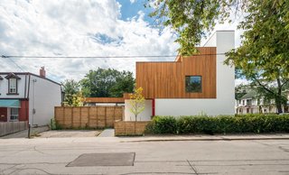 The primary residents, a professional couple, their young son, and downsizing parents, compound the savings of communal living by renting out a ground-floor and basement unit. 
