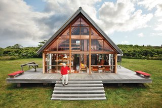 In 2009, Dwell editor-in-chief Amanda Dameron joined Jens Risom on his return to his 1967 prefab off the coast of Rhode Island, where he's been readying it for his family's next generation. The A-framed structure, shown here, is bordered by a low stone wall, an aesthetic element that appears throughout the land. 