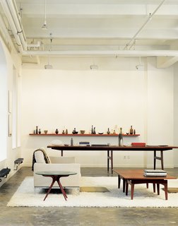 Can you spot the Risom in this picture? It's the oversize conference table in Bob Weinstein's live/work Manhattan loft, and it "supposedly came from the conference room of the Kinney Shoe Corporation," he says. Weinstein uses the table to display part of his Scandinavian pottery collection.