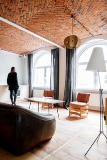 All This Warehouse Stores Nowadays Is Impeccably Cool Furniture - Photo 1 of 4 - The living room rug is a Polish textile from the 1930s. Most of the furniture is vintage from Denmark, the Czech Republic, Poland, or the Netherlands. 