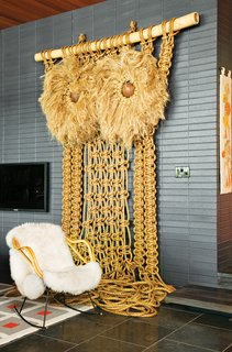 Jonathan Adler and Simon Doonan Go Trippy Contemporary on Shelter Island - Photo 5 of 12 - Andy Harman's macrame Owl punctuates the living room with a California-craft sensibility while the midnight-blue brick imbues the space with a "German-Brutalist-1960s kind of feel," says Adler. "It gives the room a nice architectural gravitas."
