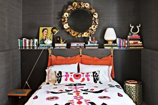 Jonathan Adler and Simon Doonan Go Trippy Contemporary on Shelter Island - Photo 8 of 12 - Adler's Slate grass cloth, a material he likes because it feels natural, sheathes a guest room's walls. Ravello and Nixon side tables flank the bed, which is covered with Adler's Alexander duvet. A reissued mirror by renowned metal artist C. Jere rounds out the eclectic room.
