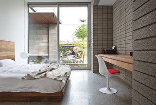 A Glo-Ball pendant from Flos and a Saarinen chair brighten a guest bedroom. The teak headboard is from Central Station.