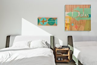 The children's bedroom, which is located next to the playroom, has beds from Bensen and artworks by Aaron Eskridge from Just Modern.