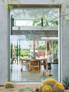 A floor-to-ceiling window frames the dining area.