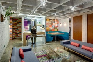 The raw concrete shell is accented everywhere by vivid patterns. Certain columns are dressed in wooden floorboards that were upcycled from an old building in the Colonia Condesa, then painted a patchwork of different colors. 