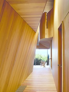 The house that architect John Wardle designed for a couple in coastal Fairhaven, Australia, twists and bends to comply with local laws that prevent buildings from disrupting the ridgeline views from the Great Ocean Road.
