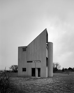 The Iconic Home That Still Looks as Good as New - Photo 4 of 6 - The private guest quarters are nestled on the ground floor, while the public spaces (open-plan living-dining room and kitchen on the second level; studio and master bedroom on the top) are elevated to capitalize on views out past the dunes to the Atlantic Ocean.