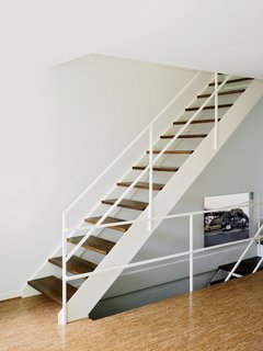 The floating staircase is a decidely elegant synthesis of form and function. "It's one of the reasons we wanted the townhouse" (as opposed to a villa), says Alexandra. The details are oddly reminiscent of the George Nelson Steel Frame desk in the office upstairs.