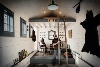 This is How You Combine Modern Architecture, Flea Market Finds, and Art All Together - Photo 4 of 8 - Hernandez had been visiting Camp Wandawega since he was a child and when the opportunity presented itself, the couple acquired the camp in 2004. The couple continues to be busy inviting people collaborate on structures while they rebuild the camp, which features a variety of cabins and structures on the grounds. Camp Wandawega has even extended into collaborations with brands such as Land of Nod, Anthropologie, and the motor cycle company URAL. This garage-turned-cottage is just one dwelling converted by the couple. 