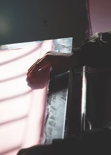 As shown here, the artisans delicately handle colored paper sheets that line the architectural house boxes from the collection.