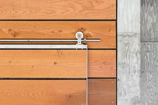 Architect Michael Cobb used Douglas fir harvested from the site throughout the house, such as on a sliding door outfitted with Swiss Rod SS hardware from the Real Carriage Door Company.</p><p><br>