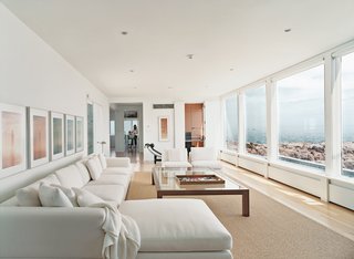 In the living room, there's a black leather Le Corbusier lounge and a Minotti sofa set.