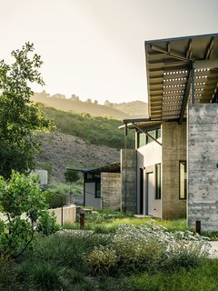 Trainor planted native grasses and yarrow as a visual buffer between the house and the natural site. Feldman chose Douglas fir beams as the board forms for the site-poured concrete walls. "The rough texture of the concrete helps tie the house to this dynamic and wild setting," he says.