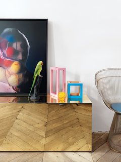 While Aumas designed the gilded table, Warren Platner gets credit for the vintage lounge chair for Knoll.
