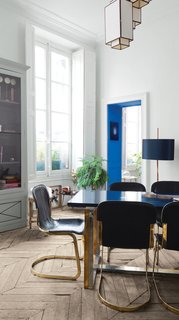 In the home of artistic director Jean-Christophe Aumas, the designer presents his collection of pieces as a mixture of vintage and contemporary classics, showcased in a traditional Parisian apartment. Pops of color on doors or paneling enliven the typical French architectural elements, while the rustic chevron floors keep it from feeling too fussy or over-the-top.