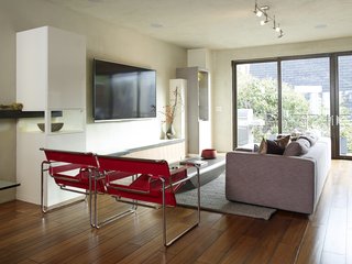 The living room is furnished with Wassily chairs by Marcel Breuer, a Limbo coffee table from Roche Bobois, and a Reid sofa from Design Within Reach.