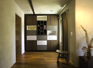 The apartment is filled with storage, including this custom unit in the master bedroom by Tom Clossey.