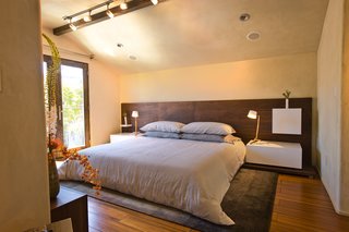 The platform, headboard, lacquer nightstands, and shelves in the bedroom are all custom designed by LOCZI and built by Tom Clossey.