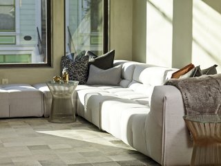 A modular Tufty-Too sofa by Patricia Urquiola for B&B Italia fills a corner of the lounge area. It's paired with side tables by Warren Platner.