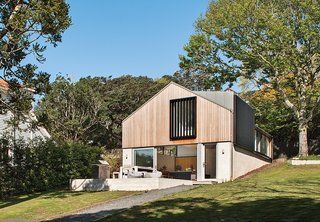 An architect reimagined an outdated brick garage by designing a graceful new family home atop its foundation.
