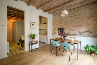 A confused layout meant that the original apartment had a series of dark, confined rooms. The designers eliminated a third bedroom and enlarged the living room. The previous kitchen was separated from the living area by a tight hallway. Nook's reconfiguration attached the kitchen directly to the living room, at the client's request.