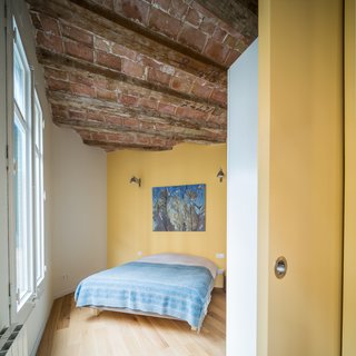 The apartment, approximately 765 square feet in total, contains one master bedroom as well as a smaller sleeping space for guests. A sliding door closes off the bedroom from the living area when total privacy is desired. 